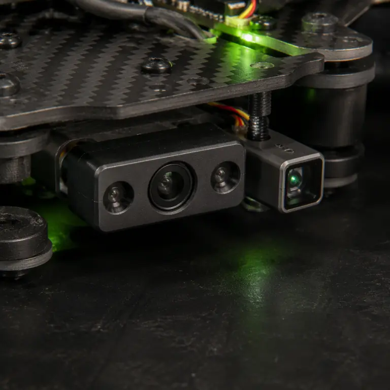 Macro studio photograph of a small downward-facing optical flow camera module and a tiny laser rangefinder mounted on a carbon fiber drone underside plate, dark workbench, lime green status LED glow, precision electronics aesthetic, photorealistic, no people faces, no text, no logos
