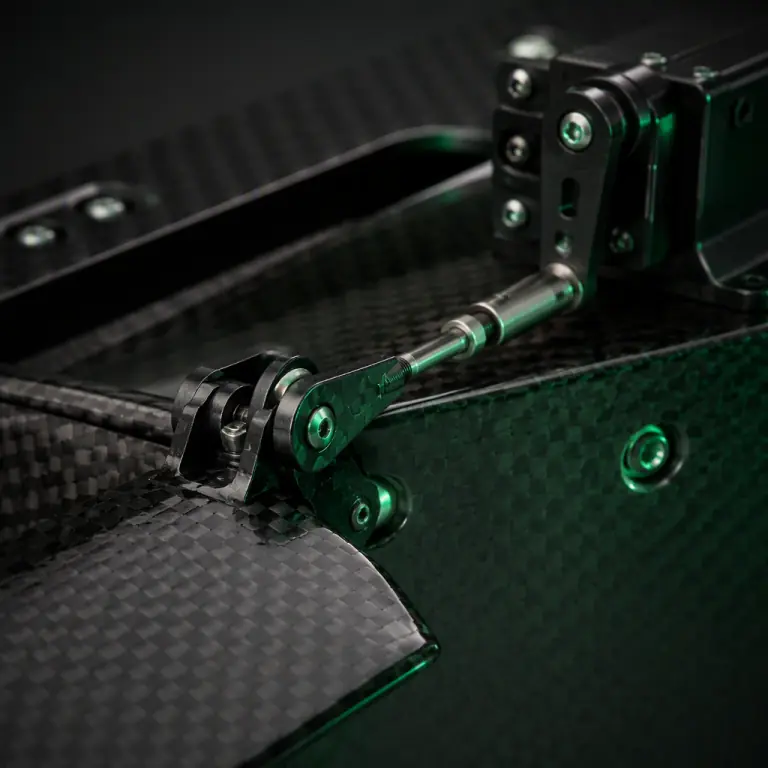 Macro photograph of a carbon fiber aircraft control surface hinge with a metal pushrod linkage and servo arm, dark studio, precision mechanical engineering aesthetic, green accent light, no people faces, no text, no logos